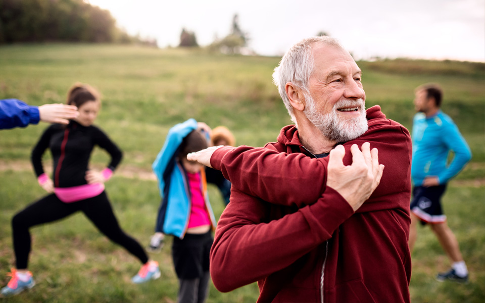 Man in red sweatshirt stretching